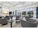 Bright and airy clubhouse with stylish seating areas and expansive windows overlooking the pool at 3488 Great Banyan Way, Wesley Chapel, FL 33543