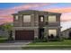 Inviting two-story home with a two-car garage, manicured lawn, and beautiful landscaping at 3488 Great Banyan Way, Wesley Chapel, FL 33543