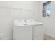 Bright laundry room featuring a washer, dryer, and wire shelving at 3488 Great Banyan Way, Wesley Chapel, FL 33543