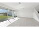 Bright and spacious living room with tile flooring and large windows offering great natural light and backyard views at 3488 Great Banyan Way, Wesley Chapel, FL 33543