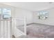 Open loft area with natural light and neutral walls at 3488 Great Banyan Way, Wesley Chapel, FL 33543