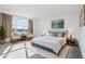 A beautifully staged main bedroom with a calming color palette and plush furnishings at 3488 Great Banyan Way, Wesley Chapel, FL 33543