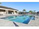Resort-style pool with ample lounge chairs and lush landscaping, perfect for relaxation at 3488 Great Banyan Way, Wesley Chapel, FL 33543