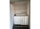 Compact laundry area featuring a white washer and dryer with wire shelving above at 3802 N Oak Dr # W22, Tampa, FL 33611