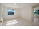 Bright empty bedroom with a tile floor and large window at 4421 28Th N Ave, St Petersburg, FL 33713