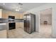 Well-lit kitchen featuring stainless steel refrigerator, light cabinets, and tile flooring at 4421 28Th N Ave, St Petersburg, FL 33713