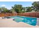 Sparkling backyard pool with spa and tiled trim, enclosed by a wooden fence for privacy at 4421 28Th N Ave, St Petersburg, FL 33713