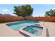 Backyard pool with a spa and tiled trim, surrounded by a well-maintained patio and a wooden fence at 4421 28Th N Ave, St Petersburg, FL 33713