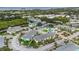 Beautiful aerial shot of a community with a pool, tennis courts, and lush landscaping at 455 Alt 19 S # 65, Palm Harbor, FL 34683
