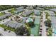 This aerial view showcases community amenities, tennis courts, a pool, and well-maintained landscaping at 455 Alt 19 S # 65, Palm Harbor, FL 34683