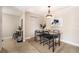 Dining room with neutral paint, tile floor, modern table, contemporary light fixture and artwork at 455 Alt 19 S # 65, Palm Harbor, FL 34683