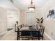 Inviting dining area with modern table and chairs, a contemporary light fixture and artwork at 455 Alt 19 S # 65, Palm Harbor, FL 34683
