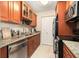 Cozy kitchen features stainless steel appliances, granite countertops, and wooden cabinets at 455 Alt 19 S # 65, Palm Harbor, FL 34683