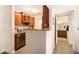 Kitchen with stainless steel appliances and granite countertops plus a pass through to the dining area at 455 Alt 19 S # 65, Palm Harbor, FL 34683
