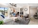 Bright living room featuring a comfortable sofa, stylish rug, and a sliding door to the outside at 455 Alt 19 S # 65, Palm Harbor, FL 34683
