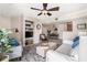 Comfortable living room open to dining area, features a ceiling fan and built in shelving at 455 Alt 19 S # 65, Palm Harbor, FL 34683