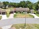 Aerial view of single-story home featuring mature landscaping and covered parking at 503 Finsbury Cir # A, Sun City Center, FL 33573
