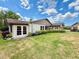 Well-manicured backyard featuring a lush lawn and an enclosed lanai at 503 Finsbury Cir # A, Sun City Center, FL 33573