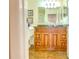 Bathroom with a granite countertop, wooden cabinets, vanity mirror, and tile flooring at 503 Finsbury Cir # A, Sun City Center, FL 33573