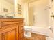 Tiled bathroom featuring a shower-tub combo, vanity mirror, and granite countertop at 503 Finsbury Cir # A, Sun City Center, FL 33573