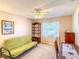 Bedroom with a ceiling fan, closet, desk, and futon at 503 Finsbury Cir # A, Sun City Center, FL 33573