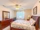 Bedroom featuring traditional decor, a ceiling fan, and ample natural light at 503 Finsbury Cir # A, Sun City Center, FL 33573