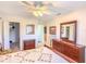 Bright bedroom with a ceiling fan, carpet, and closet with a variety of shelves and drawers for storage at 503 Finsbury Cir # A, Sun City Center, FL 33573