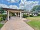 Spacious carport featuring concrete driveway with decorative landscaping on either side at 503 Finsbury Cir # A, Sun City Center, FL 33573