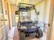 Golf cart in a sunroom with a clear windshield and good tires at 503 Finsbury Cir # A, Sun City Center, FL 33573