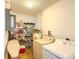 Bright laundry room featuring washer, dryer, shelving, and water heater at 503 Finsbury Cir # A, Sun City Center, FL 33573