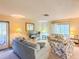 Cozy living room with floral print furniture, television, and glass panel entry door at 503 Finsbury Cir # A, Sun City Center, FL 33573