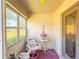 Inviting sunroom with bright light, and cozy seating area near glass paneled door at 503 Finsbury Cir # A, Sun City Center, FL 33573