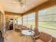 Relaxing sunroom with ceiling fan, large windows, and comfortable seating at 503 Finsbury Cir # A, Sun City Center, FL 33573