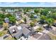 Aerial view of a neighborhood with solar panels on roofs and a serene lake nearby at 5137 Springwood Dr, Tampa, FL 33624