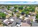 Aerial view showing homes with solar panels and a nearby lake at 5137 Springwood Dr, Tampa, FL 33624