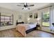 Bright bedroom features hardwood floors, a ceiling fan, and ample natural light at 5137 Springwood Dr, Tampa, FL 33624