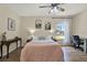 Bright bedroom features hardwood floors, a ceiling fan, and ample natural light at 5137 Springwood Dr, Tampa, FL 33624