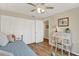 Comfortable bedroom with a daybed, wood-look floors, a closet, and a decorative vanity desk with chair at 5137 Springwood Dr, Tampa, FL 33624