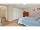 Bedroom with floral wallpaper, closet, and light-colored wood flooring at 5137 Springwood Dr, Tampa, FL 33624