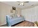 Cozy bedroom with a daybed, wood-look floors, ceiling fan, and a closet with folding doors at 5137 Springwood Dr, Tampa, FL 33624