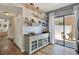 Cozy dining area with a decorative cabinet, open shelving, and access to the outdoor patio at 5137 Springwood Dr, Tampa, FL 33624