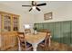 Bright dining room featuring a wooden table, matching chairs, and a charming built-in china cabinet at 5137 Springwood Dr, Tampa, FL 33624