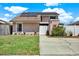 Charming two-story home featuring solar panels and a well-maintained front yard at 5137 Springwood Dr, Tampa, FL 33624
