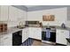 Well-lit kitchen with white cabinets, marble countertops, and stainless steel appliances at 5137 Springwood Dr, Tampa, FL 33624