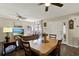 Inviting living room featuring wood floors, ceiling fan, dining table, and plenty of natural light at 5137 Springwood Dr, Tampa, FL 33624