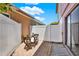 Private brick patio with a small wooden table and chairs, perfect for outdoor relaxation at 5137 Springwood Dr, Tampa, FL 33624