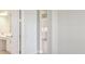 Bright, modern bathroom with a vanity and partial view into another room at 5194 Everlong Dr, Apollo Beach, FL 33572