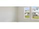 Bright bedroom featuring large windows showcasing a picturesque neighborhood view at 5194 Everlong Dr, Apollo Beach, FL 33572