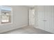 Carpeted bedroom featuring a double window and closet with double doors at 5194 Everlong Dr, Apollo Beach, FL 33572
