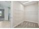 Walk-in closet with wire shelving and a view into the modern bathroom and bedroom at 5194 Everlong Dr, Apollo Beach, FL 33572